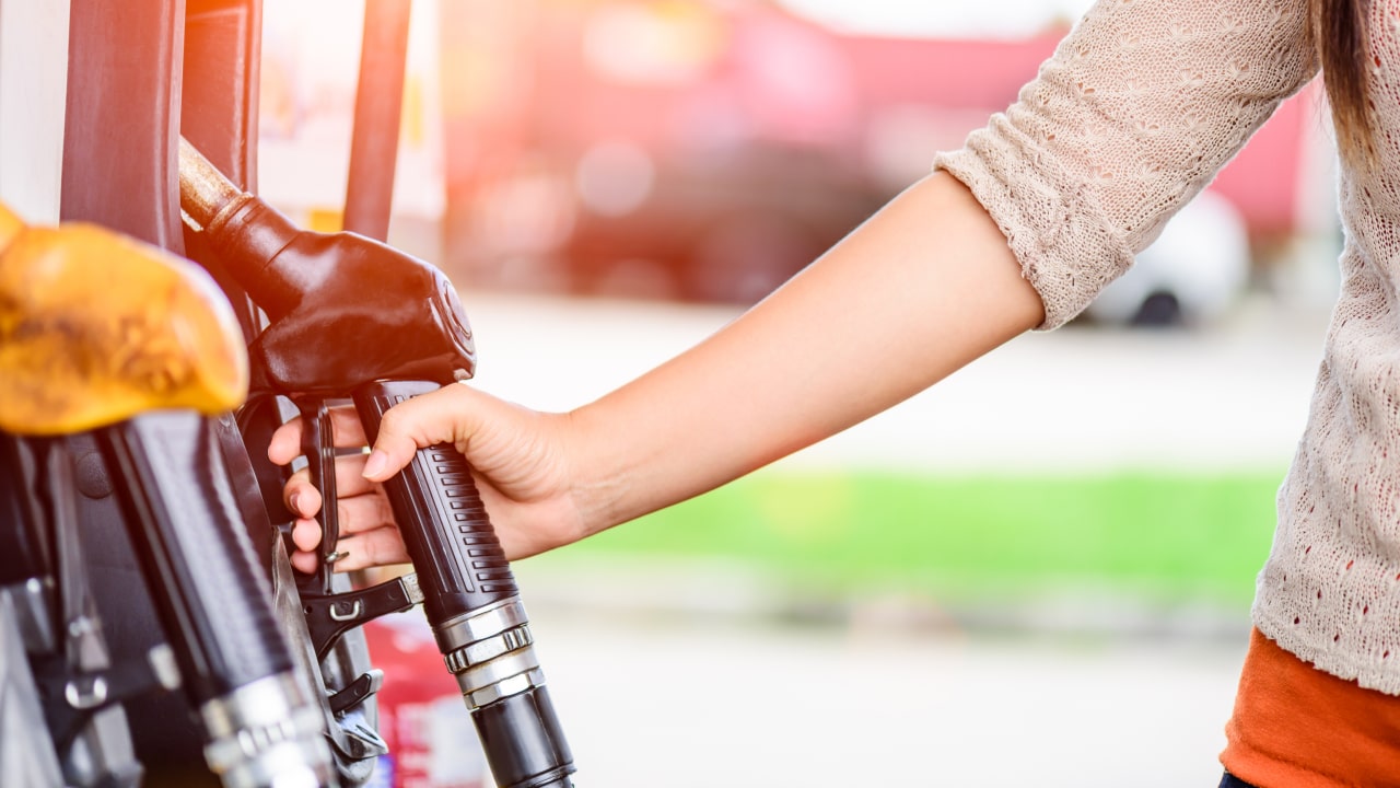 woman filling up gas tips for saving money on gas and fuel