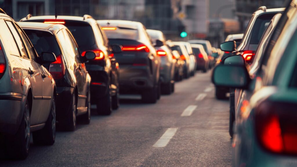 cars driving on the road in a big city they might be uber drivers