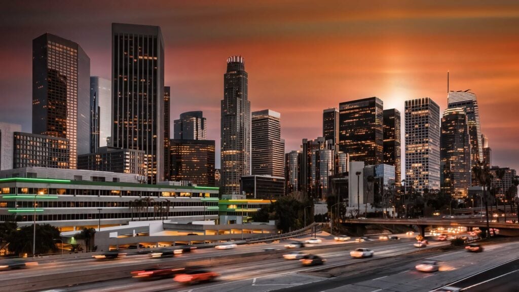 california skyline with cars driving by